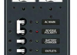 Powerboat 120V AC distribution panel with switches for AC main, reverse polarity, battery charger, outlets, and spare.