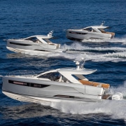 Three sleek powerboats cruising in formation on open blue waters, showcasing speed and elegance. Ideal for luxury sea adventures.