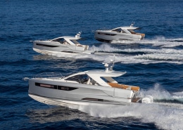 Three sleek powerboats cruising in formation on open blue waters, showcasing speed and elegance. Ideal for luxury sea adventures.