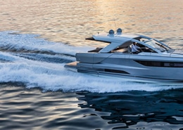 Luxury powerboat cruising at sunset, cutting through calm waters with speed and elegance. Perfect day for a boating adventure.