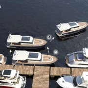 Powerboats docking strategy under windy conditions, focusing on maneuvers for safe and efficient mooring.