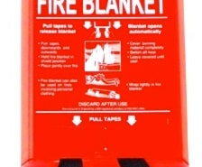 Red fire blanket container with safety instructions, essential for powerboat safety and emergency preparedness.