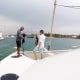 People preparing a powerboat at the marina, ready for a day of adventure on the water.