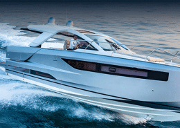 Sleek powerboat cruising at high speed on open water, showcasing modern design and performance.