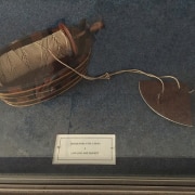 Vintage log-line and bucket display in a museum exhibit, showcasing historical nautical tools.