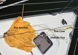 Sea anchor setup with tow and deflate lines on a boat deck, essential equipment for powerboating safety and stability.