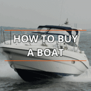 Powerboat cruising on water with How to Buy a Boat text overlaying the image.