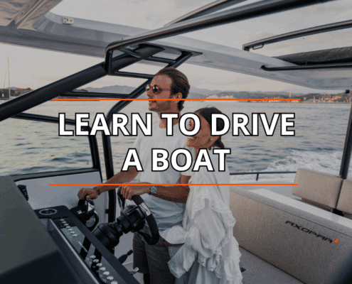 A couple learning to drive a powerboat on the water at sunset, featuring Learn to Drive a Boat text overlay.