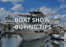 Luxury yacht at a boat show with Boat Show Buying Tips text overlay, under blue skies.