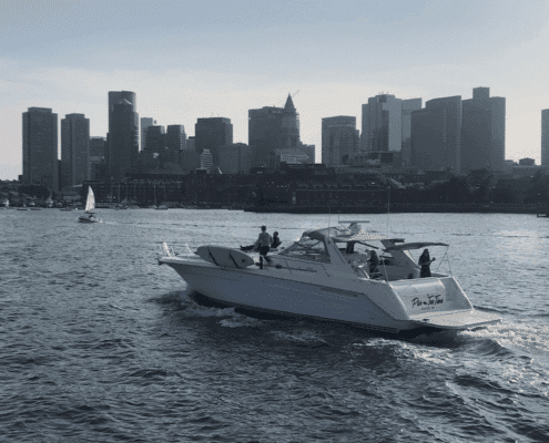 unnamed (47) Powerboat cruising near city skyline, capturing urban waterfront vibes and boating adventure.