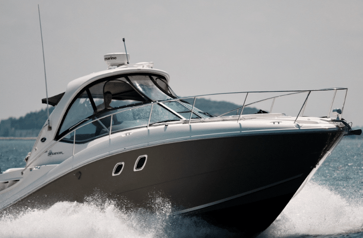 Sleek powerboat speeding through the water, showcasing its modern design and performance on a sunny day.
