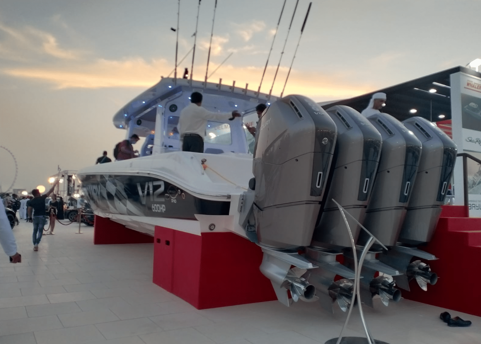 unnamed (8) Powerboat showcase with V12 600HP outboard engines at a sunset expo, attracting boating enthusiasts.